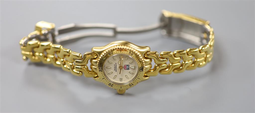 A ladys modern gilt steel Tag Heuer Professional quartz wrist watch, cased diameter 23mm, ex.crown.
